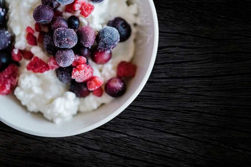 Delicious frozen berries atop creamy cottage cheese, perfect for a refreshing breakfast