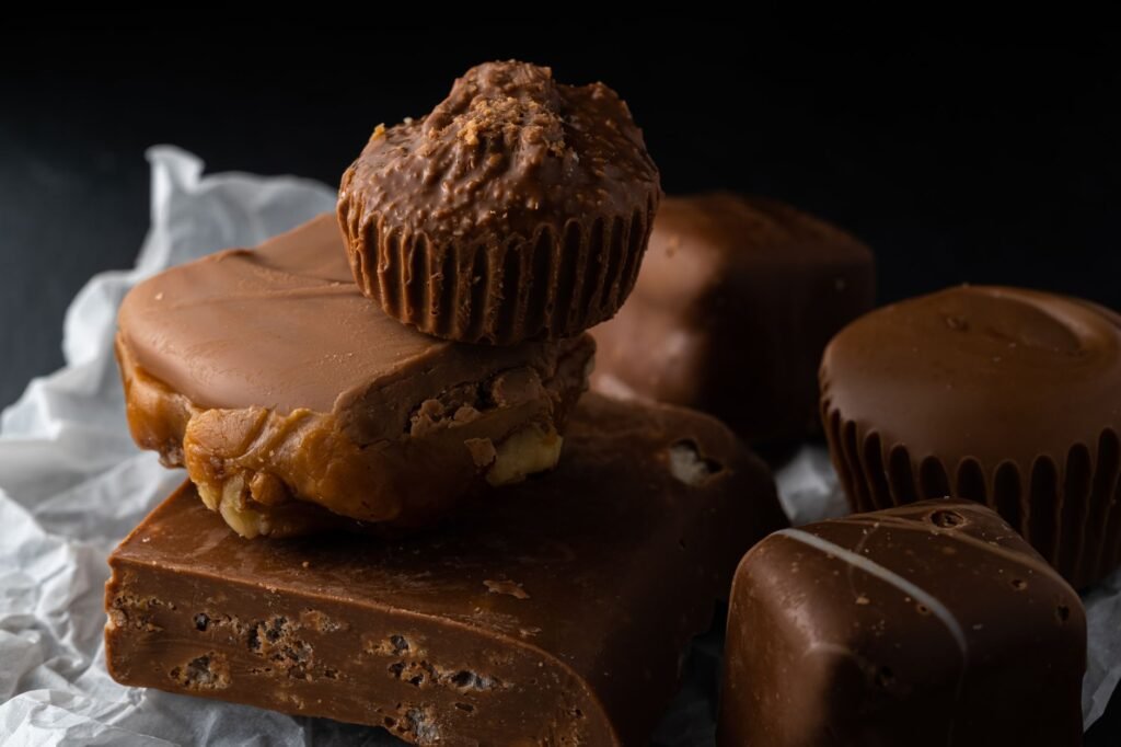 A delectable assortment of chocolate desserts including fudge and peanut clusters.