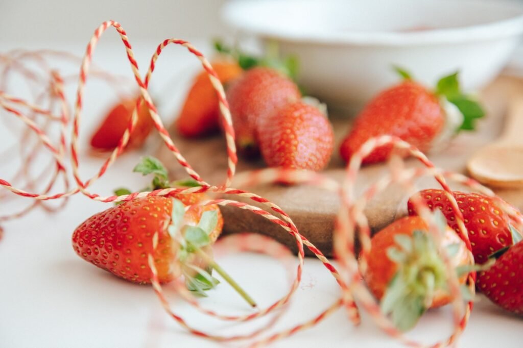 Captivating close-up of fresh strawberries on a tray with vibrant ribbon accents. Perfect for food enthusiasts