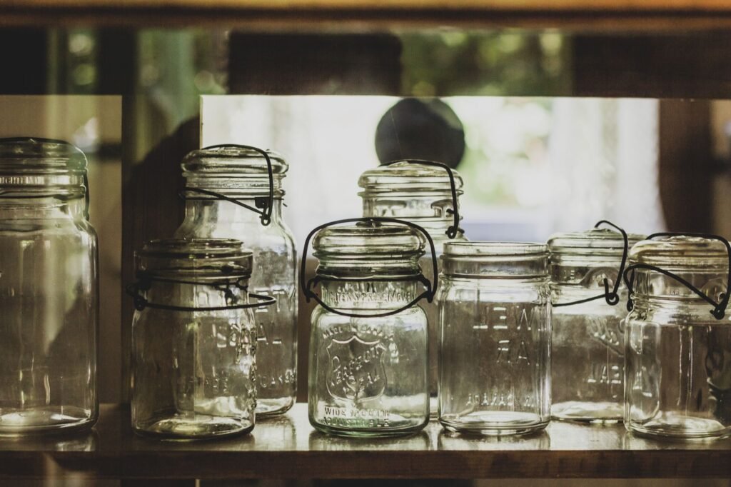 Collection of vintage mason jars on a shelf, showcasing rustic charm
