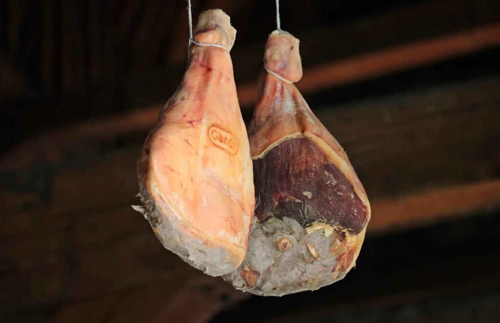 Ham hanging in a smokehouse