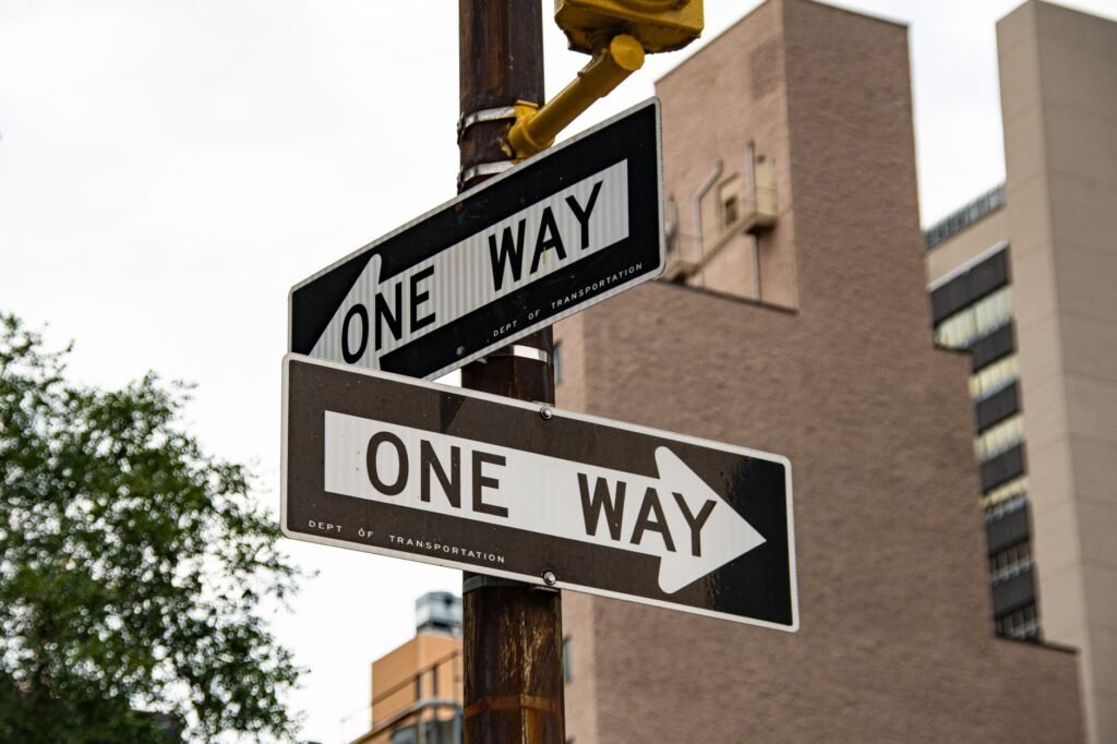Close-up of one way street signs in urban New York City setting