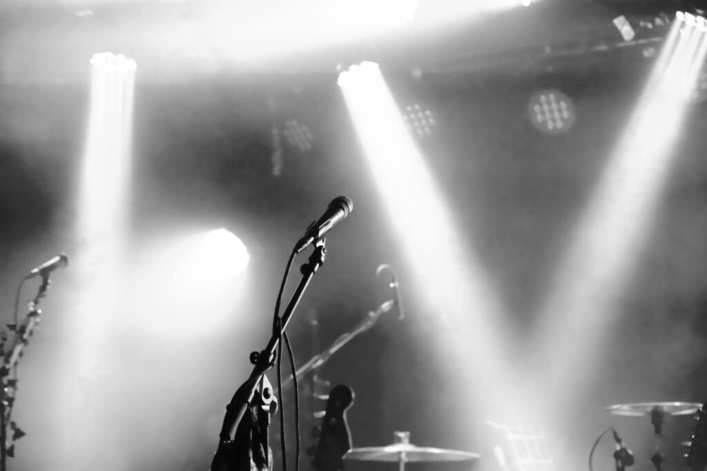 Eerie black and white stage setup with microphones and spotlights ready for a concert