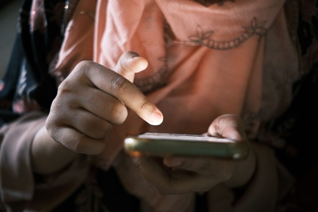 Close-up of hands using a smartphone indoors, highlighting touch technology