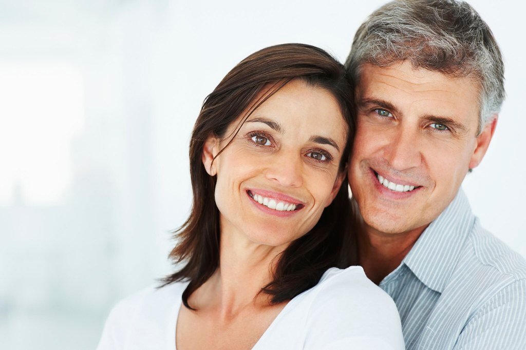 Closeup of a happy mature couple together over a background