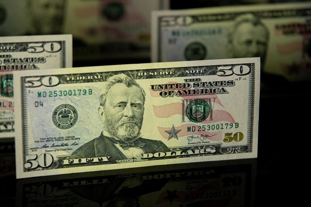 Detailed close-up of a US fifty dollar bill, emphasizing currency design and wealth theme