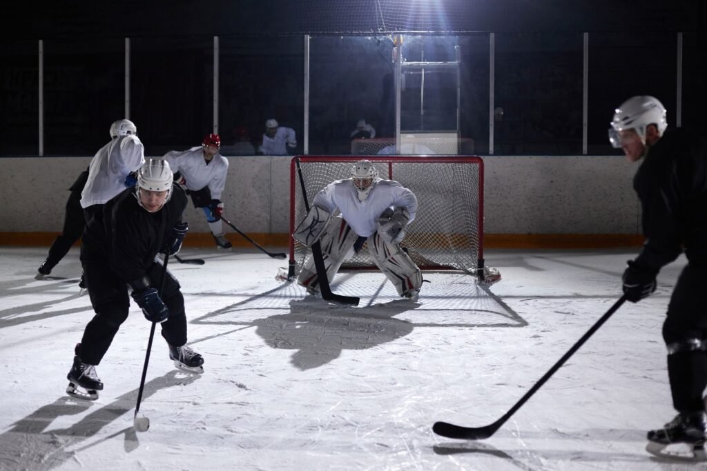 A dynamic moment captured during an ice hockey practice game in an indoor rink
