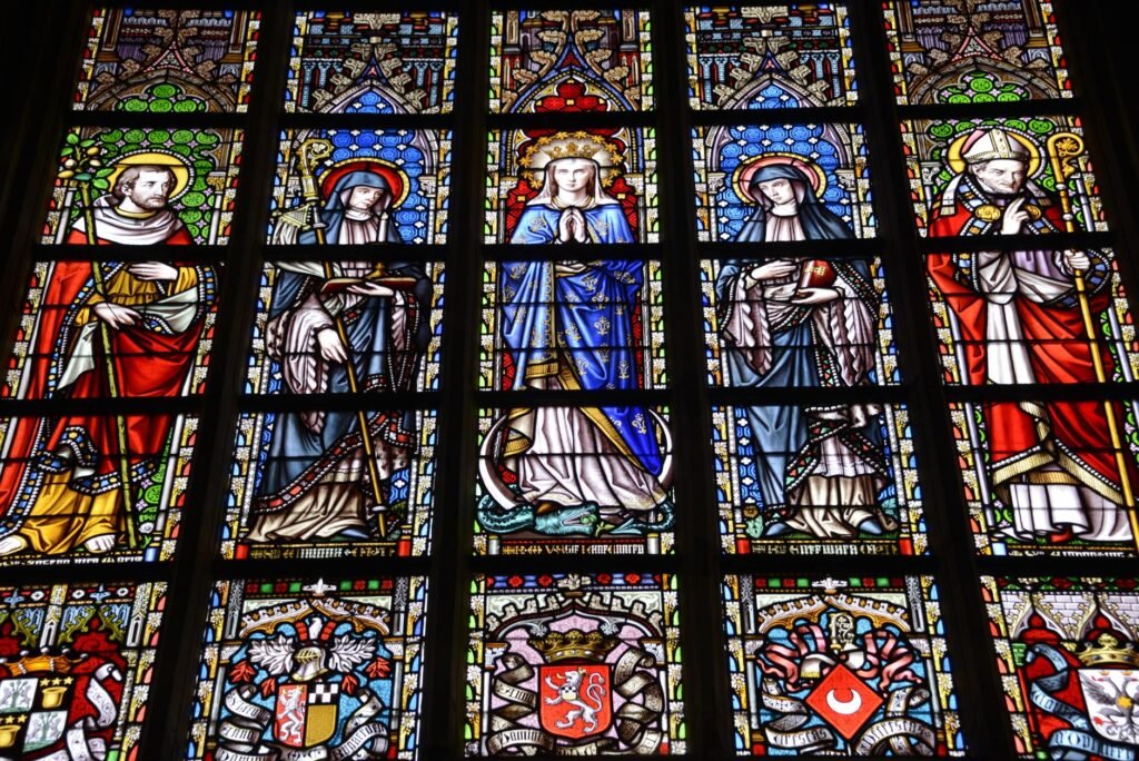 Colorful stained glass window depicting religious figures in a cathedral