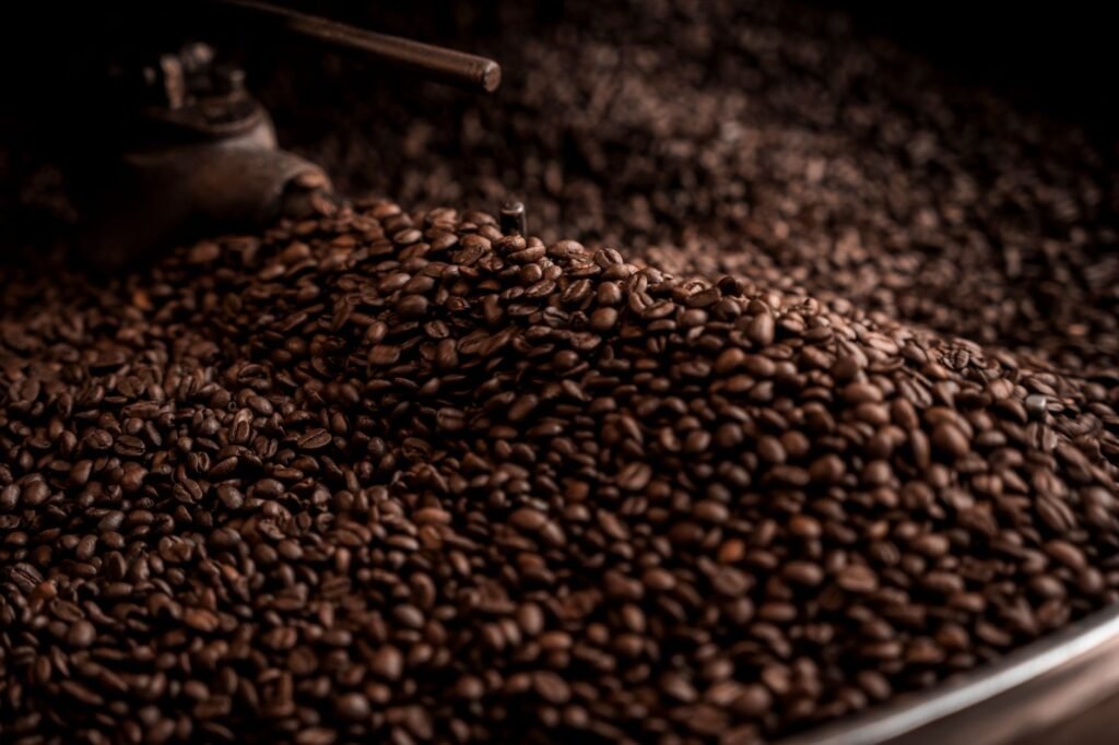 High-quality close-up image of freshly roasted coffee beans cooling in a café environment