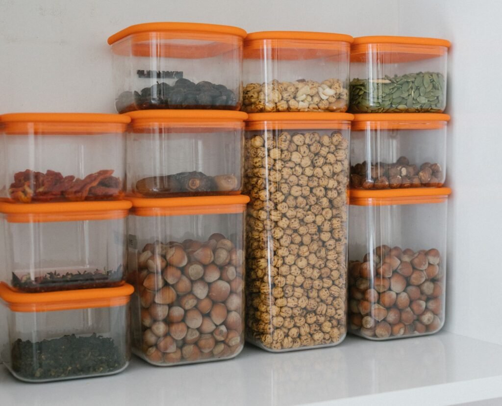 Stacked clear airtight storage containers with plastic lids holding dry goods