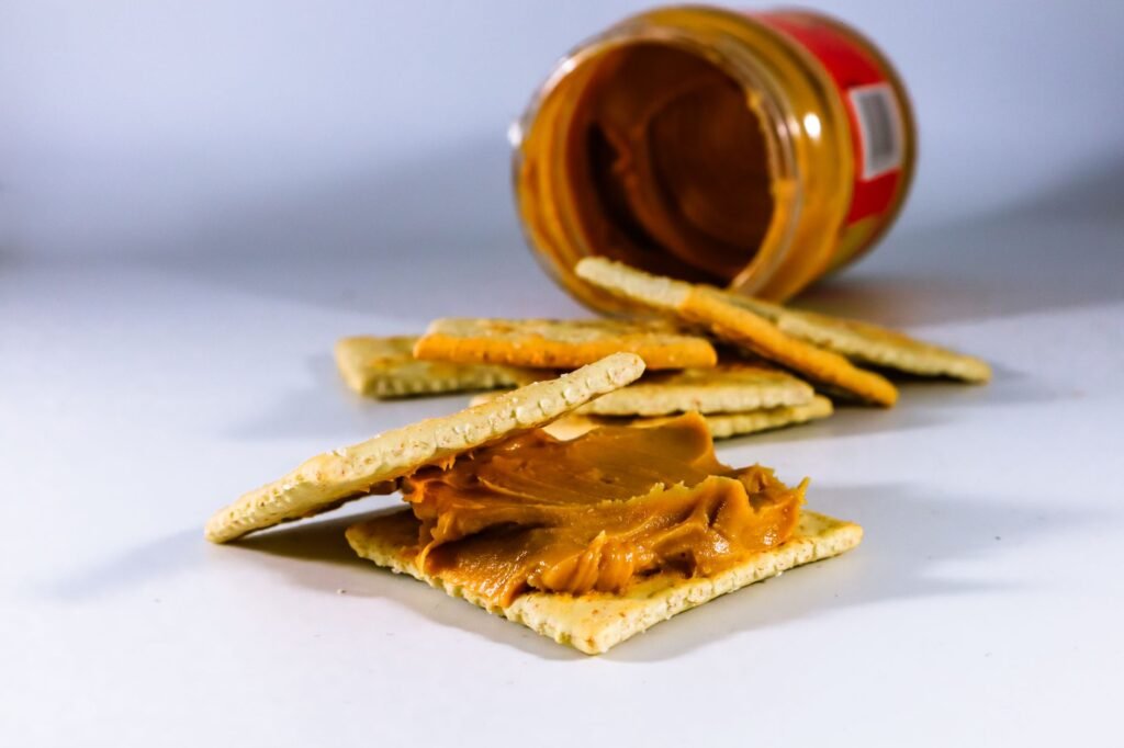Delicious peanut butter spread on crispy crackers, perfect for a tasty snack