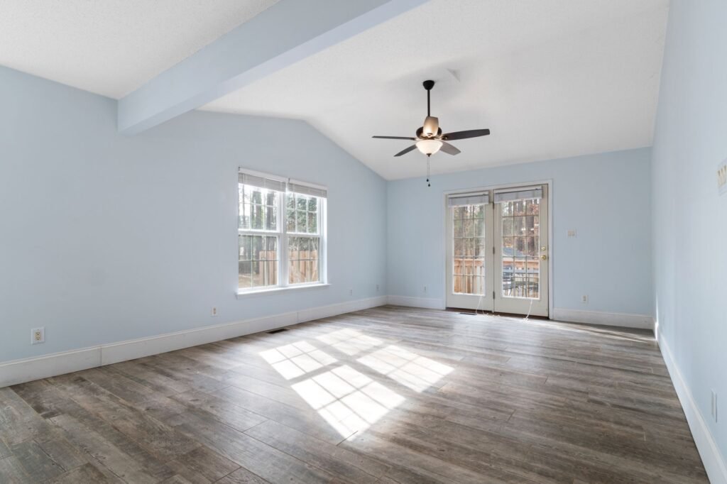 Modern empty room with blue walls and ceiling fan, ideal for interior design inspiration