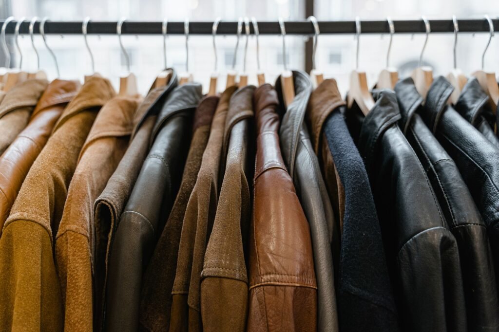 A close-up view of leather jackets hanging neatly on a rack inside a store