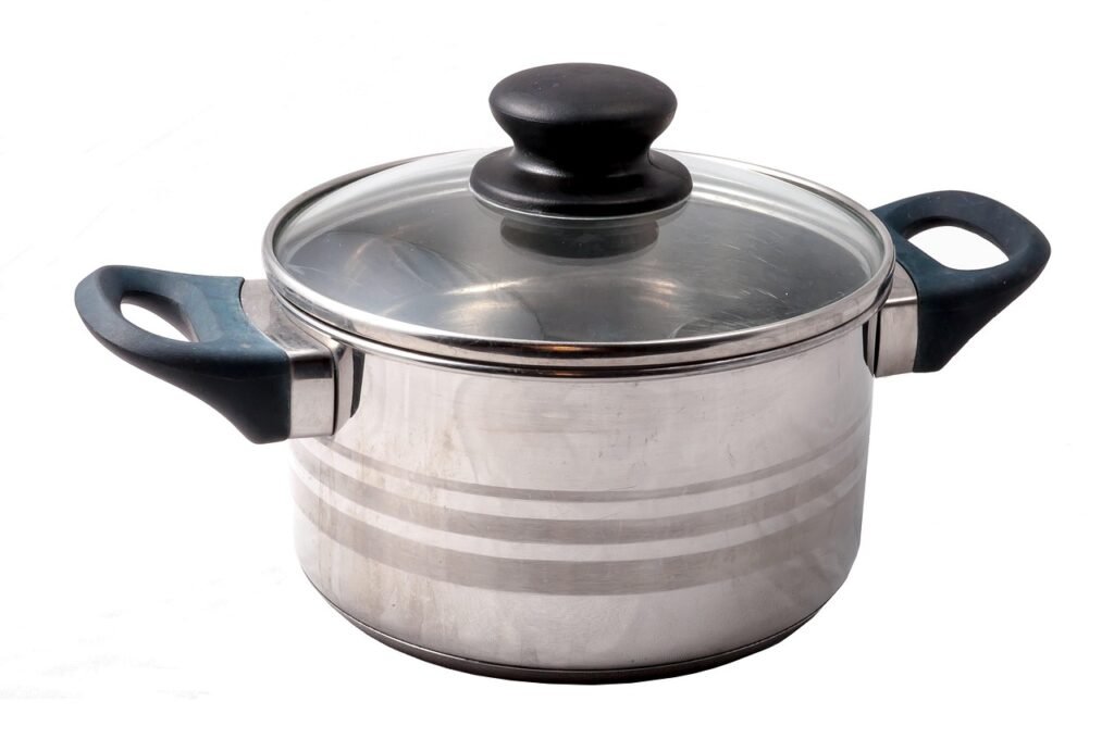 Stainless steel saucepan with a glass lid and black handles on a white background