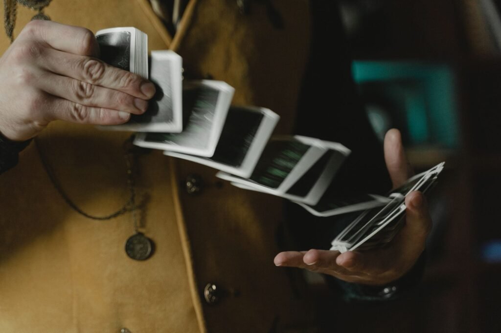 Hands performing a card flourish, springing playing cards from one hand to the other