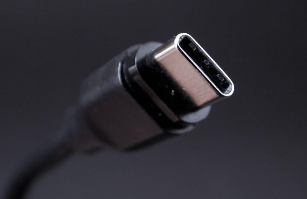 Close view of a USB C cable connector against a dark gray background
