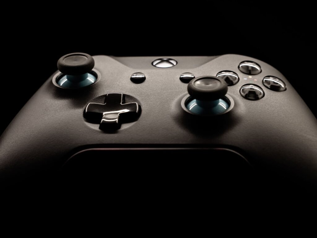 Close view of a black game controller showing both thumbsticks, directional pad and face buttons