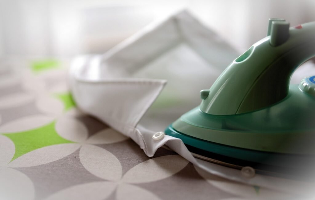 Clothes iron on ironing board