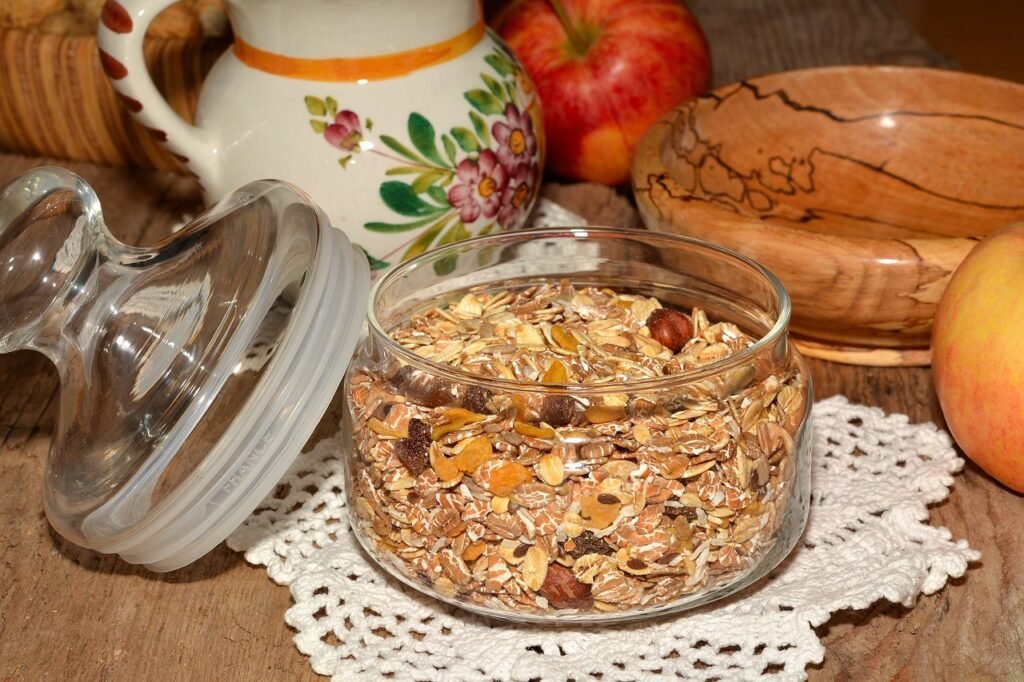 Glass jar of rolled oats mixed with nuts and dried fruit on a lace doily