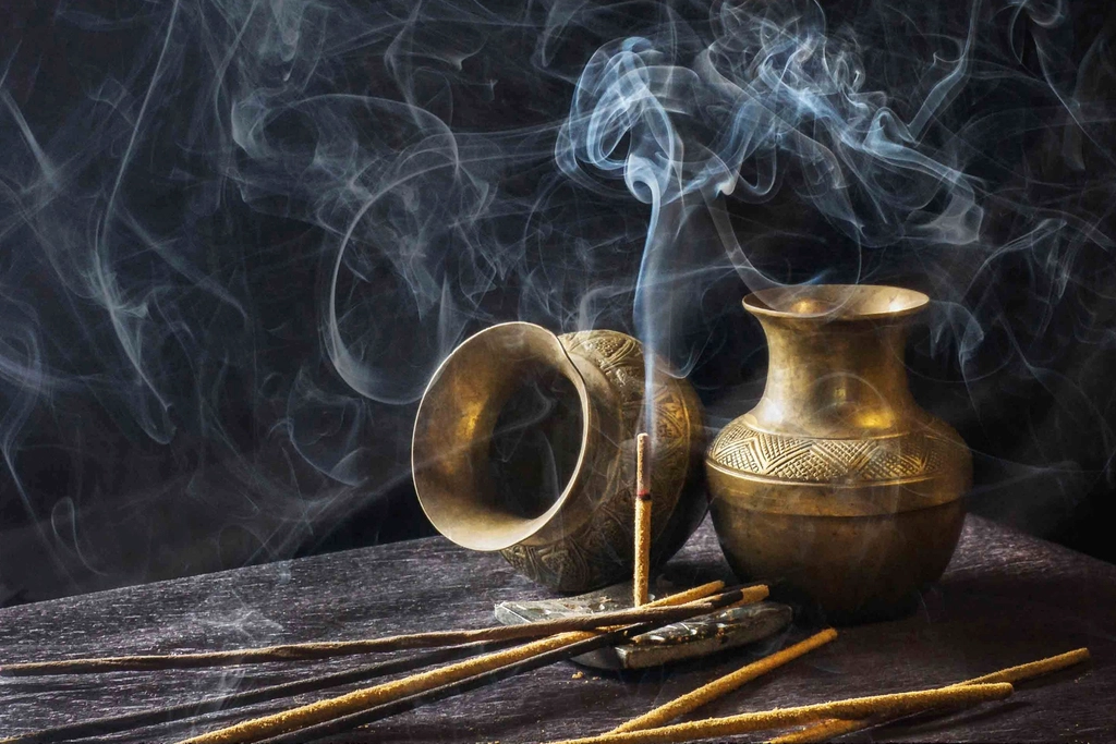 Incense sticks burning in bowl
