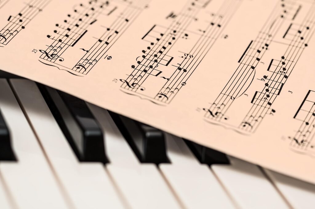 Printed piano sheet music resting over black and white piano keys
