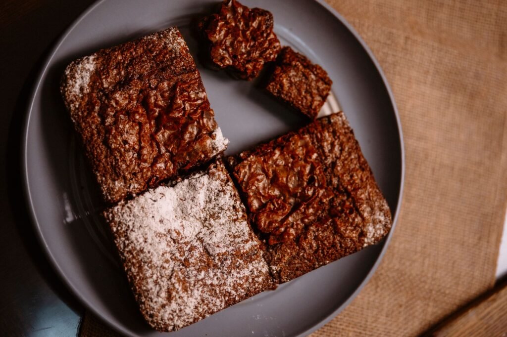 Close-up of freshly baked chocolate brownies served on a plate, perfect for dessert lovers