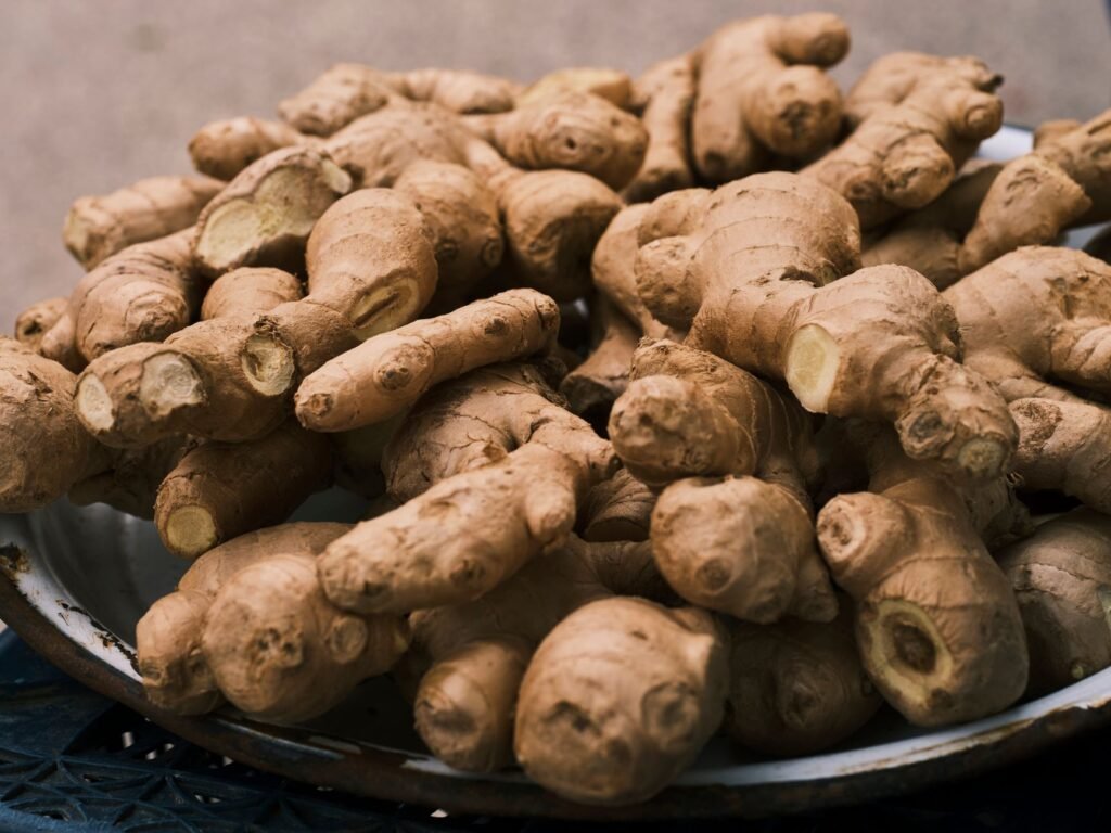 Close-up of fresh ginger roots in a bowl, highlighting its organic texture and earthy color