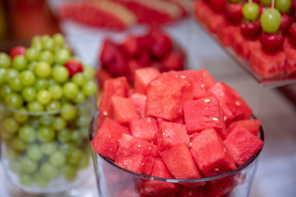 Colorful close-up of watermelon cubes with grapes and strawberries, perfect for summer refreshment