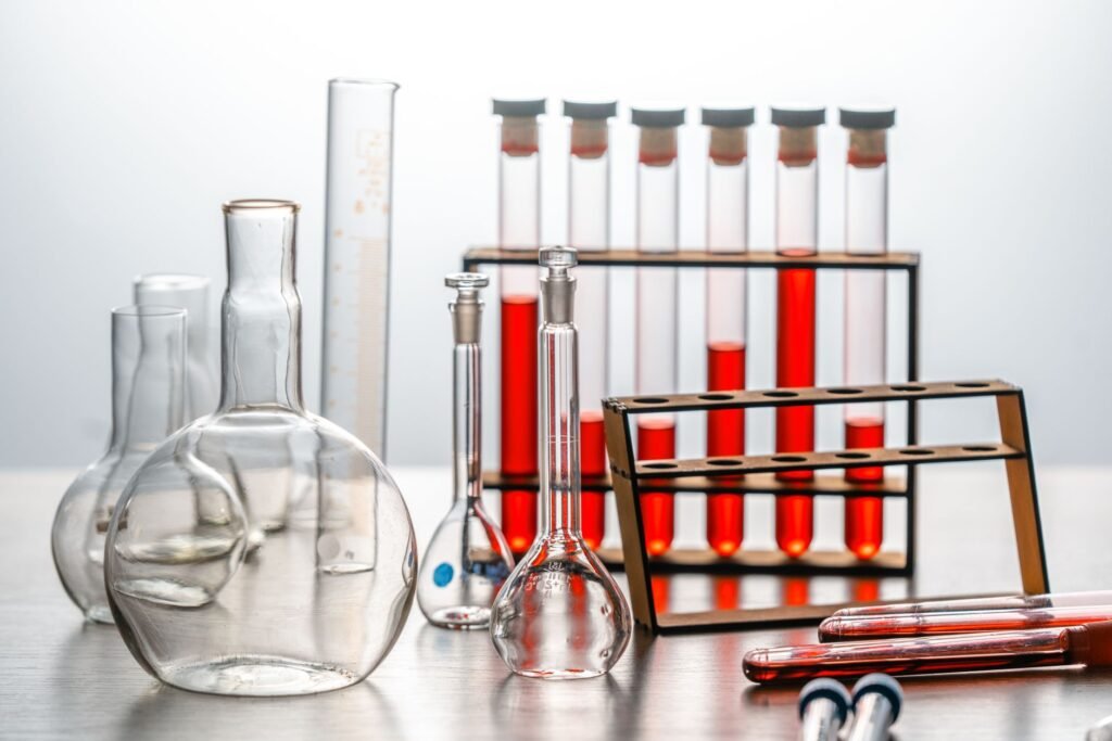 Close-up of various lab glassware with red liquids, ideal for scientific or educational use