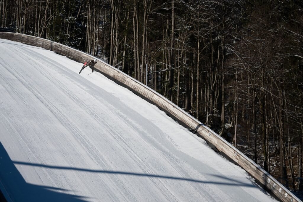 Aerial view of ski jumping in snow-covered Planica amidst Slovenian forests