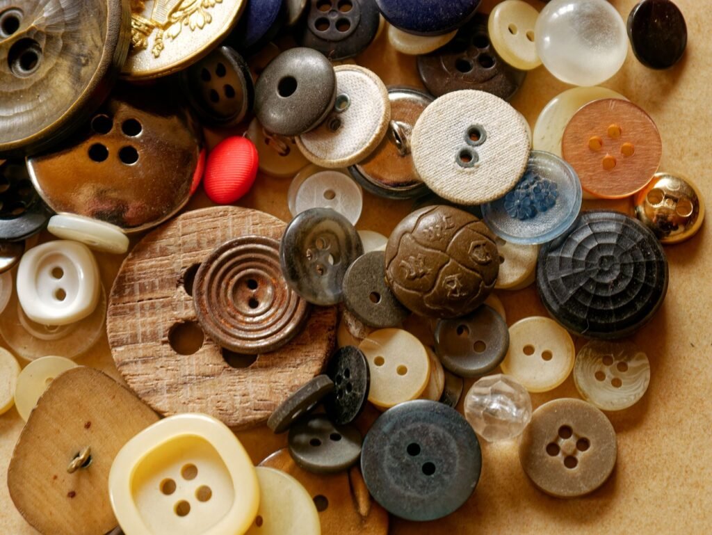 A detailed close-up of various colorful vintage buttons against a textured background