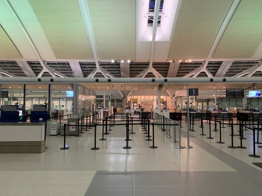 Empty check-in area of a modern airport with sleek design and organized layout