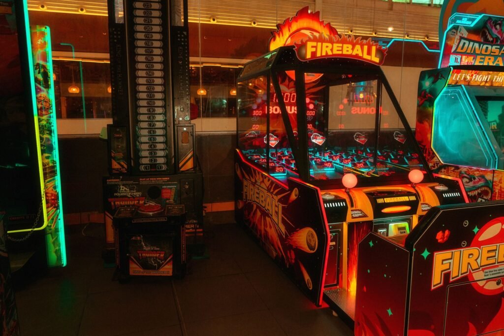 Colorful neon-lit arcade room featuring classic and modern game machines for fun and entertainment