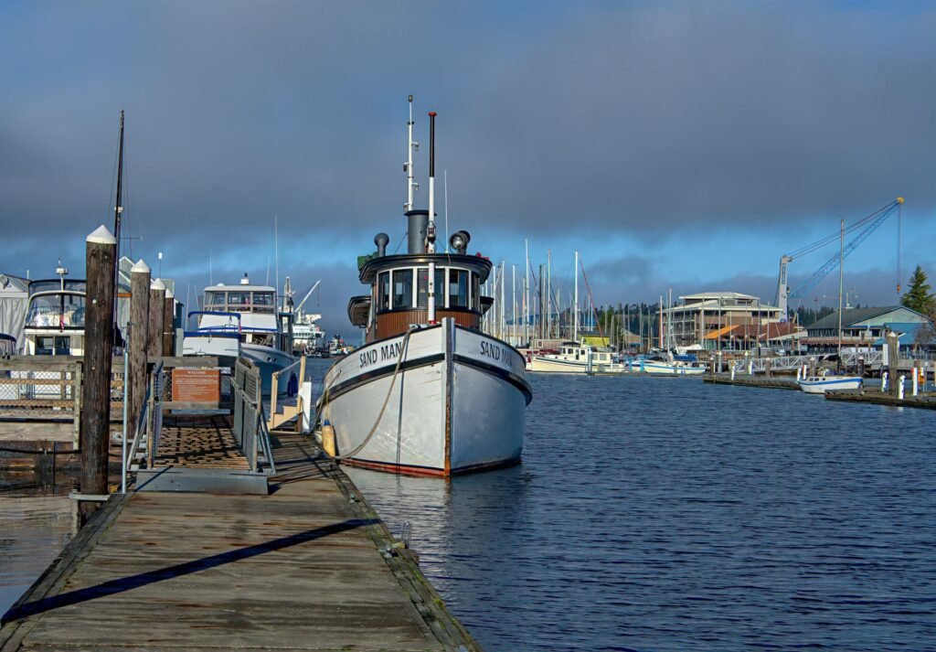 A serene view of a docked fishing boat in Olympia's harbor, capturing the peaceful morning atmosphere