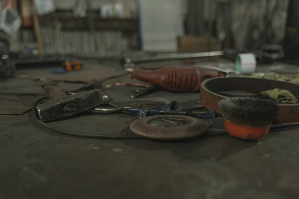 A selection of various tools scattered on a workbench in an industrial setting