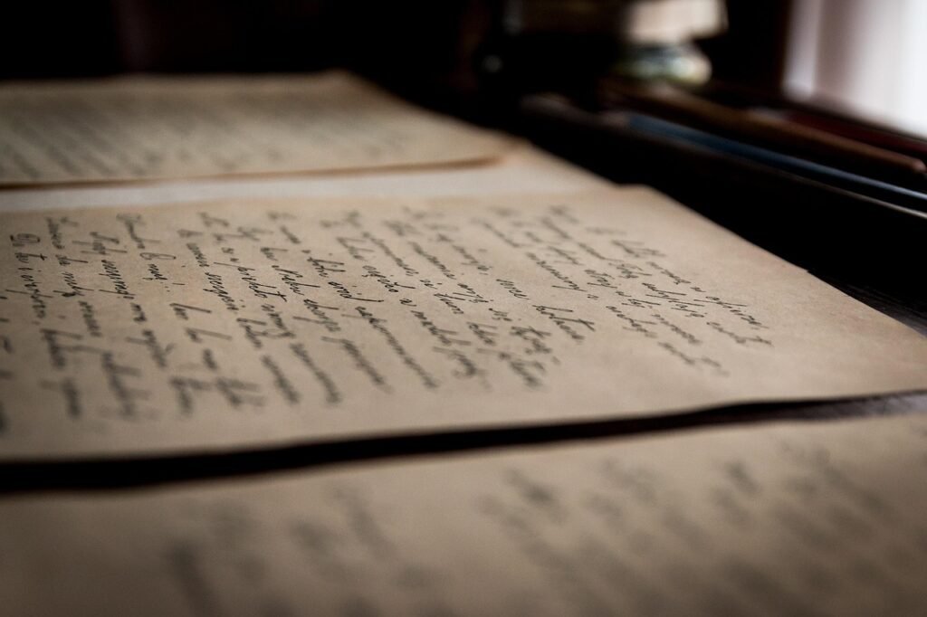 An open antique book with handwritten Latin script