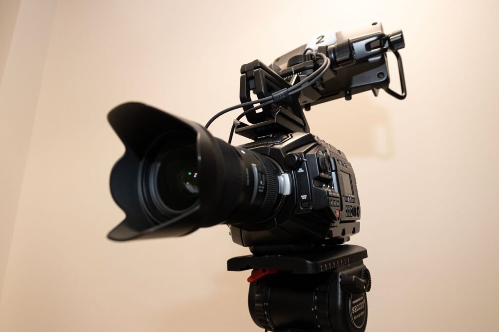 Close-up of a professional studio camera mounted on a tripod, ideal for filming projects
