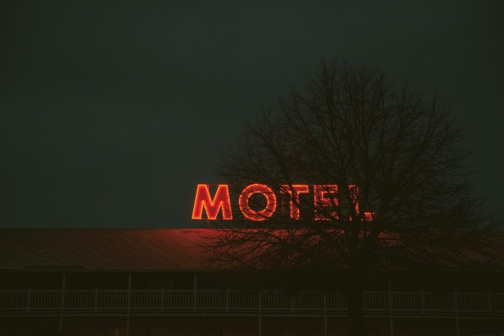 A vintage roadside motel sign lit at night