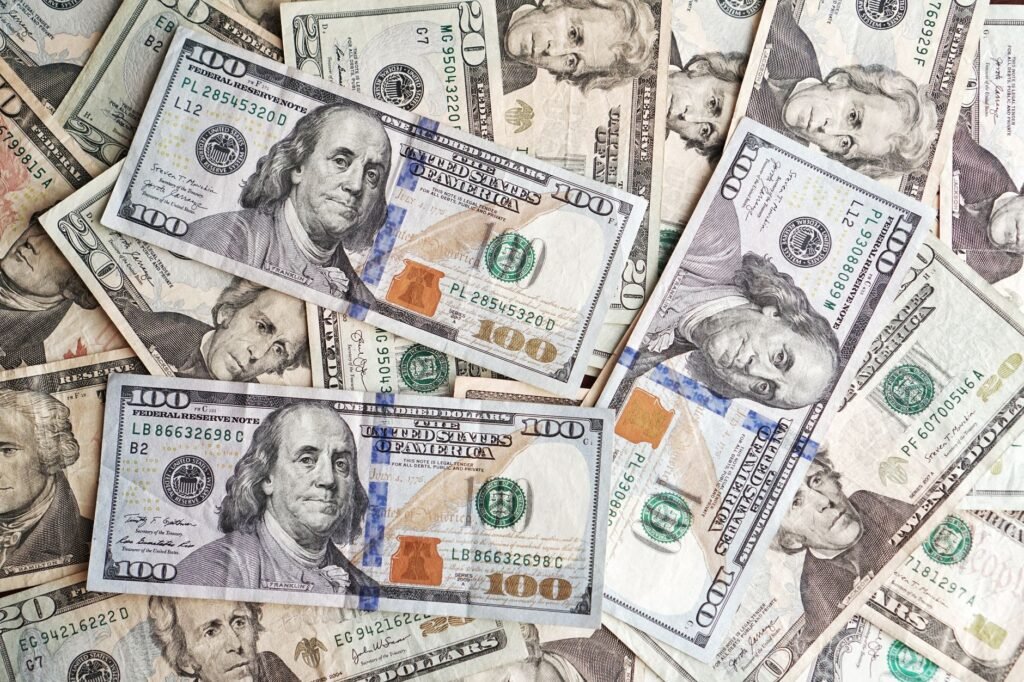 Close-up of various denominations of US dollar banknotes arranged in a pile representing finance and economics