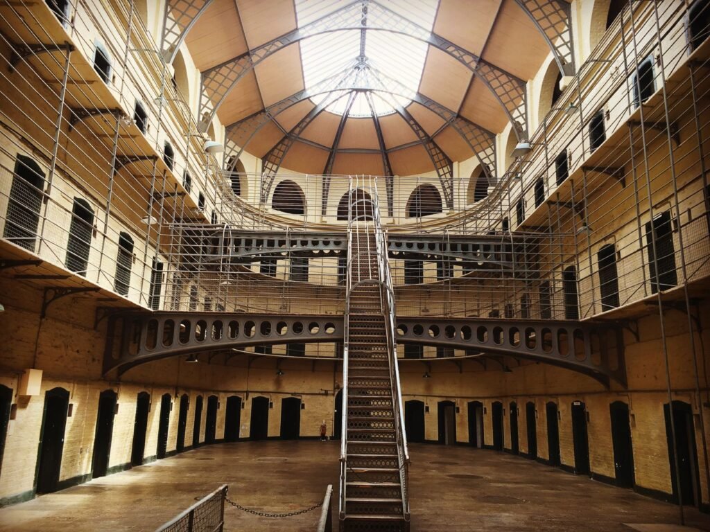Interior view of historic Kilmainham Gaol in Dublin, showcasing Victorian architecture and prison cells