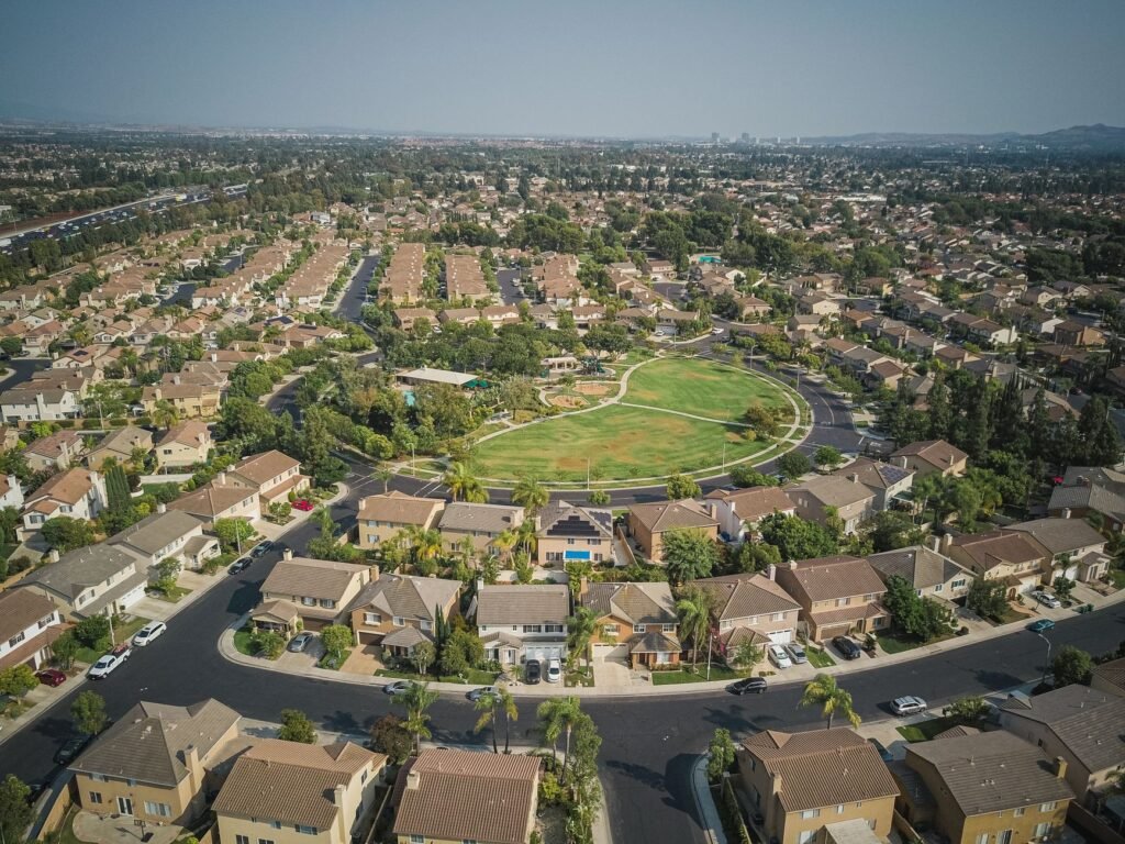 Drone aerial view of a spacious suburban neighborhood with a central park area