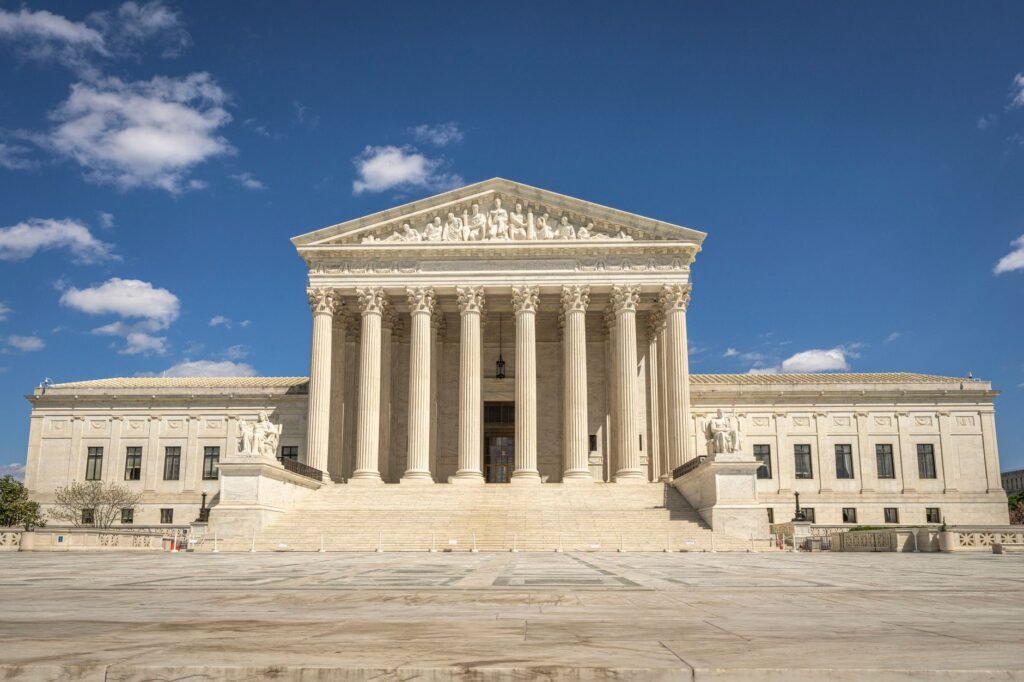 The majestic facade of the United States Supreme Court under a clear blue sky