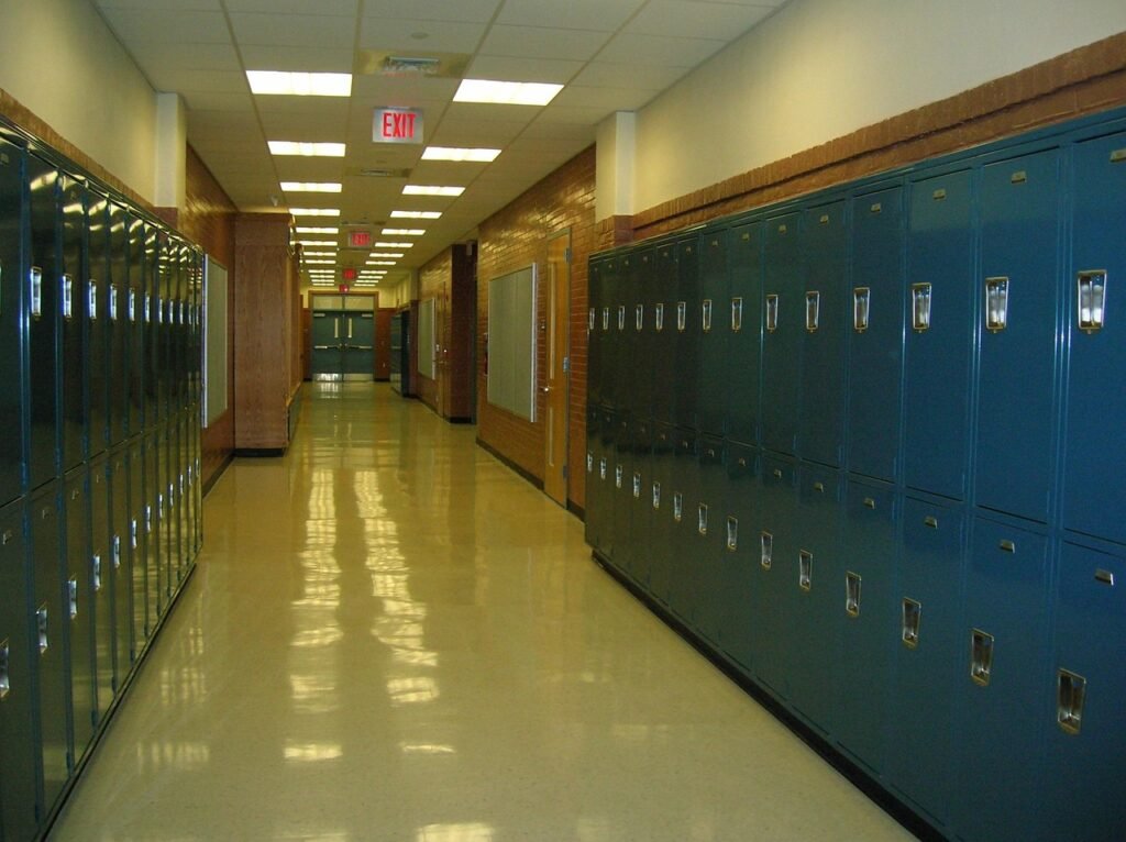 An empty middle school hallway lined with lockers