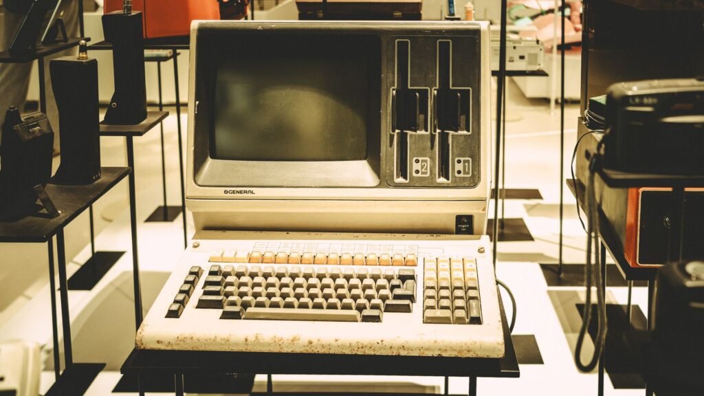 Old-fashioned General computer on display with a vintage keyboard and disk slots