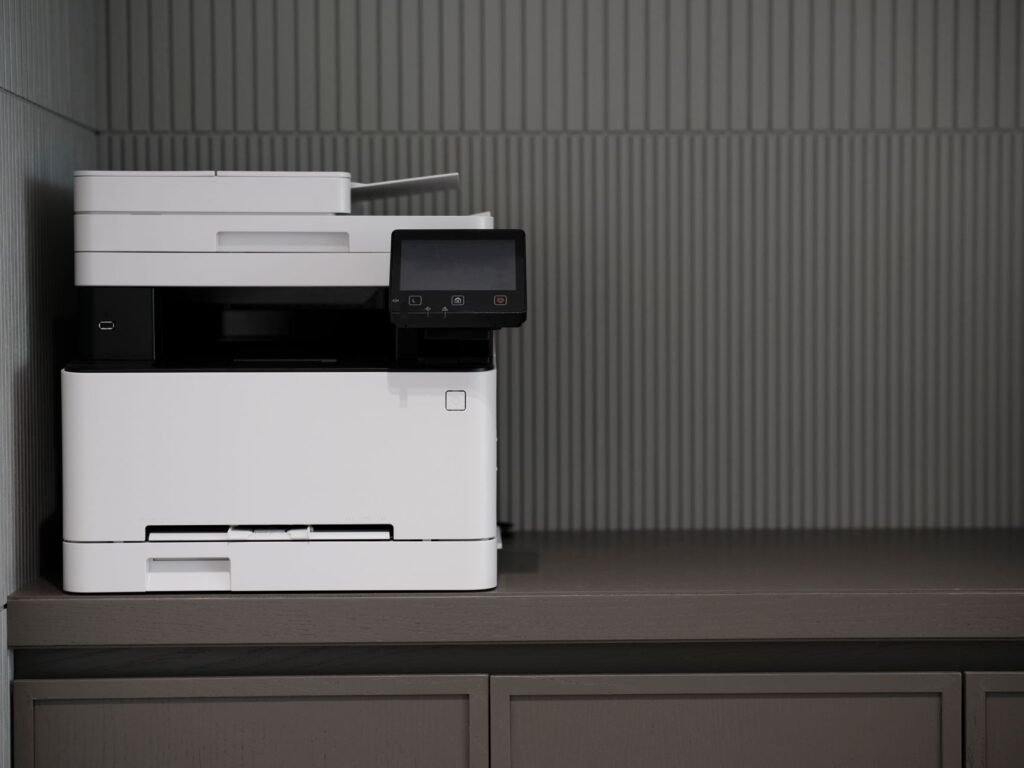A sleek, modern printer situated on a minimalist office desk with a textured background