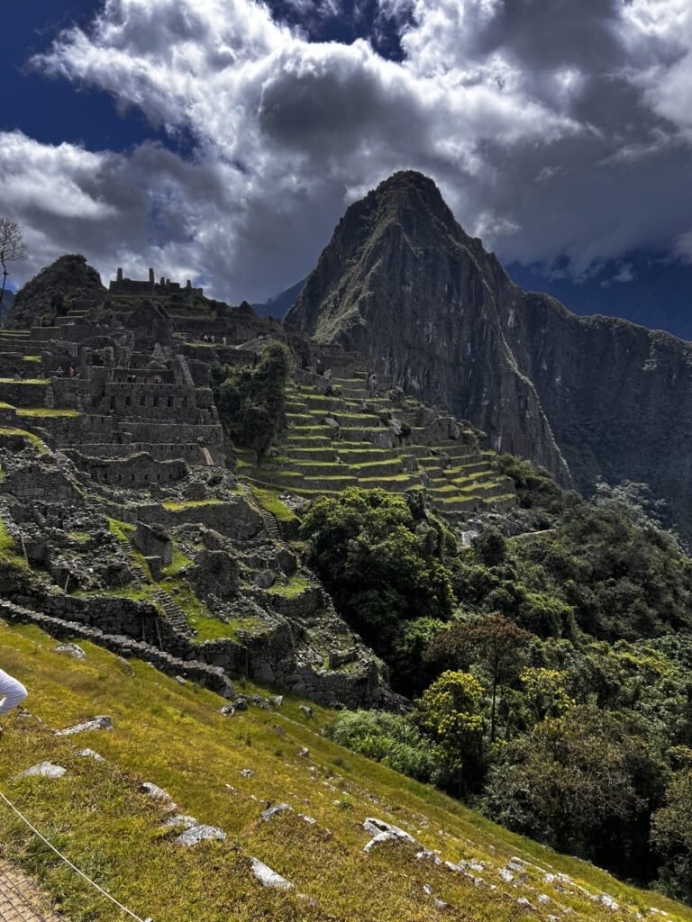 A panoramic view of Machu Picchu, showcasing ancient stone ruins perched on a steep hillside. The structure...