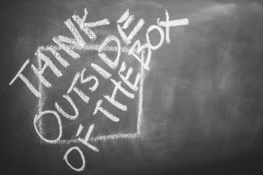 White chalk lettering of a familiar business saying written at a slant across a dark blackboard