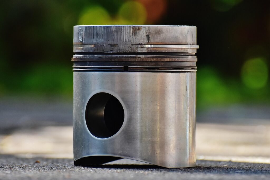 A used engine piston showing scoring on the top land