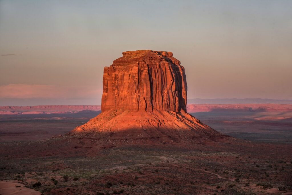 Stunning view of a butte in Monument Valley, Arizona, captured at sunset with dramatic lighting