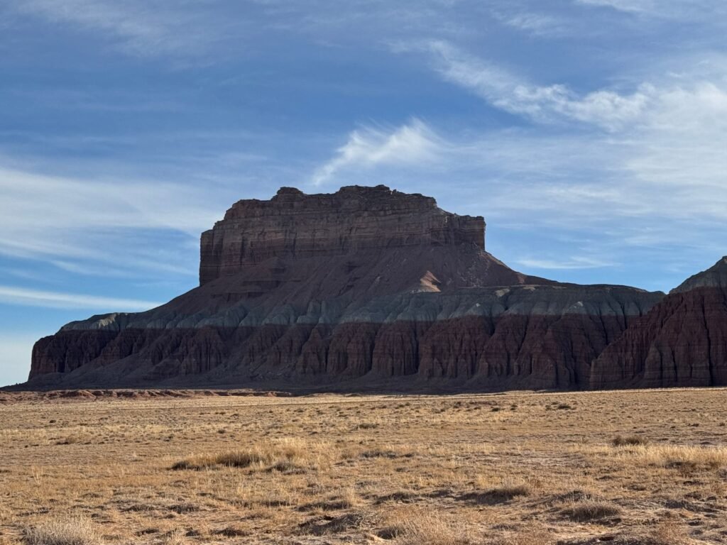 A stunning view of a towering mesa in Utah's desert, showcasing natural beauty and geological wonder